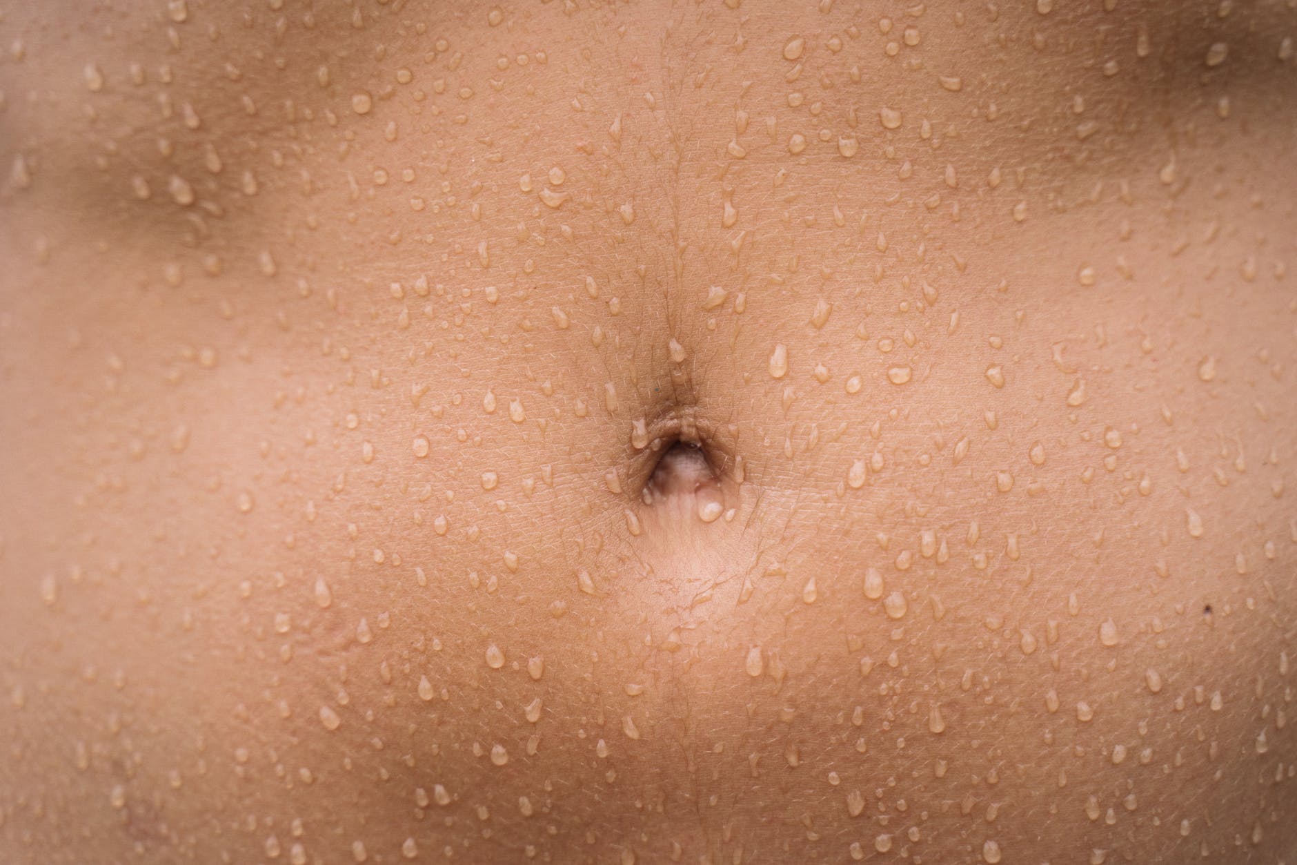 persons belly button with black hair