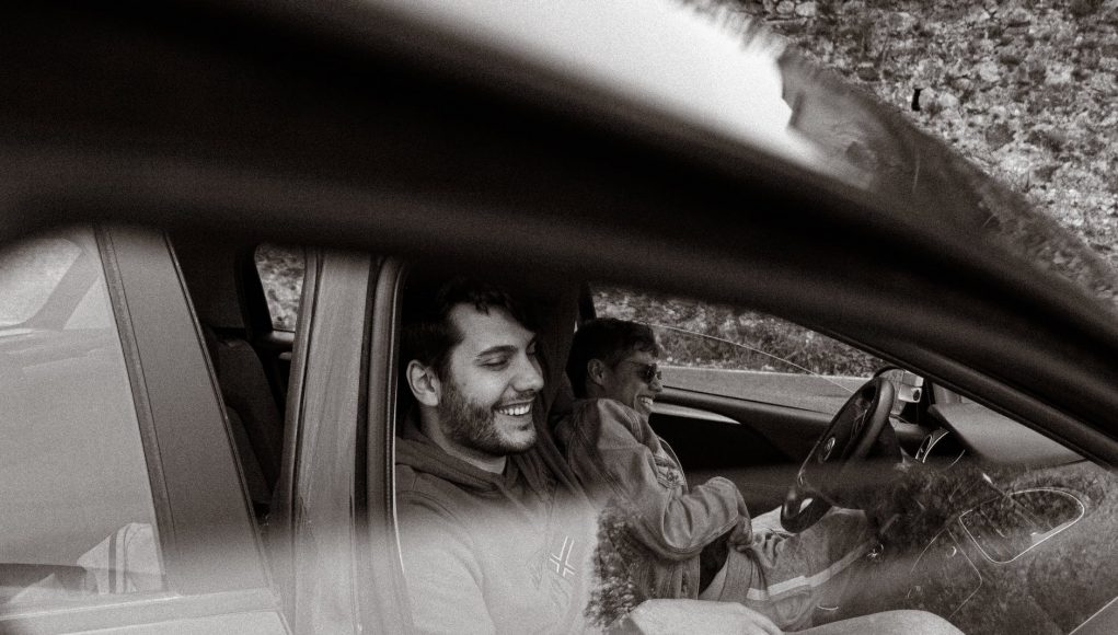 men sitting in a car and laughing