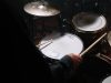 person in black long sleeve shirt playing drum
