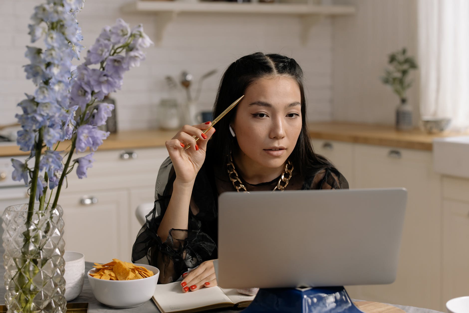 beautiful woman with red nails looking at a laptop