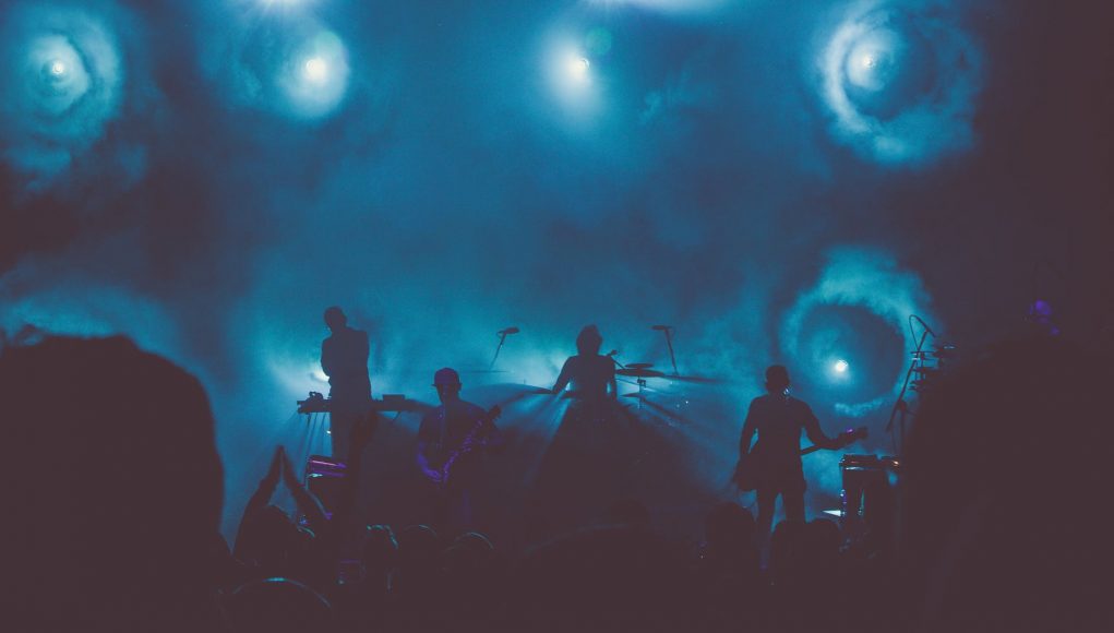 music band performs on stage during nighttime