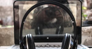Artist Interview: BIG TUSK photo of black wireless headphones in front of the laptop