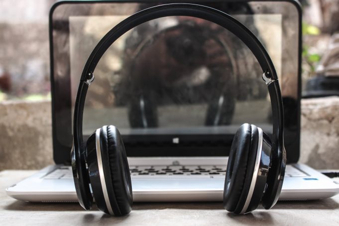 Musik Streaming vs. physische Tonträger – was eignet sich besser für Musikliebhaber? photo of black wireless headphones in front of the laptop
