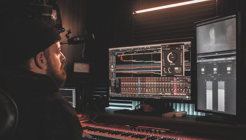 man in black jacket playing audio mixer