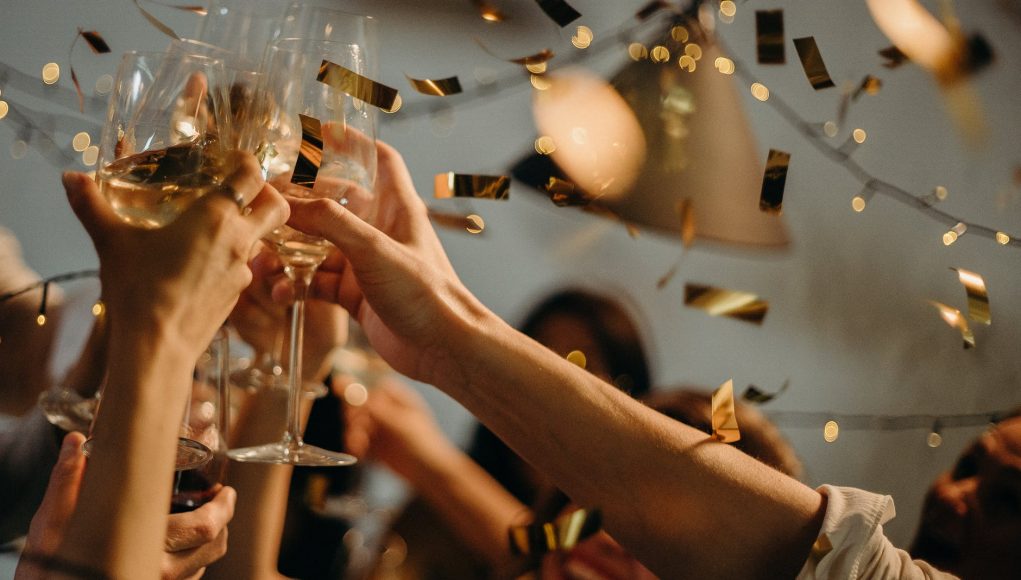 people toasting wine glasses